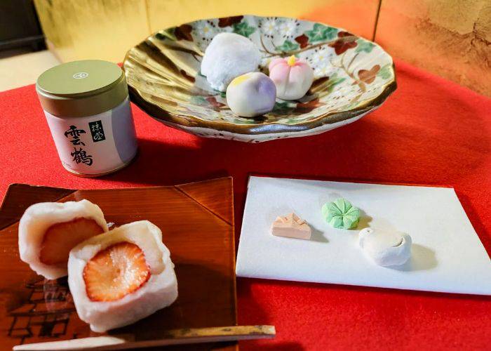 The table at a Japanese tea ceremony class, featuring wagashi and matcha tea powder.